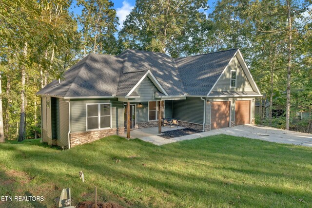 craftsman inspired home with a garage, a front lawn, and a carport