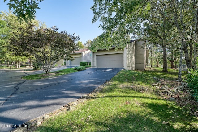 view of front of property with a garage and a front lawn