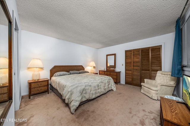 carpeted bedroom featuring a textured ceiling and a closet