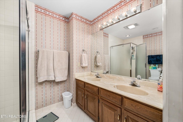 bathroom featuring vanity, toilet, and an enclosed shower