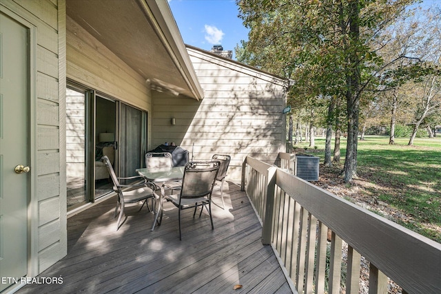 wooden terrace with area for grilling and central AC unit