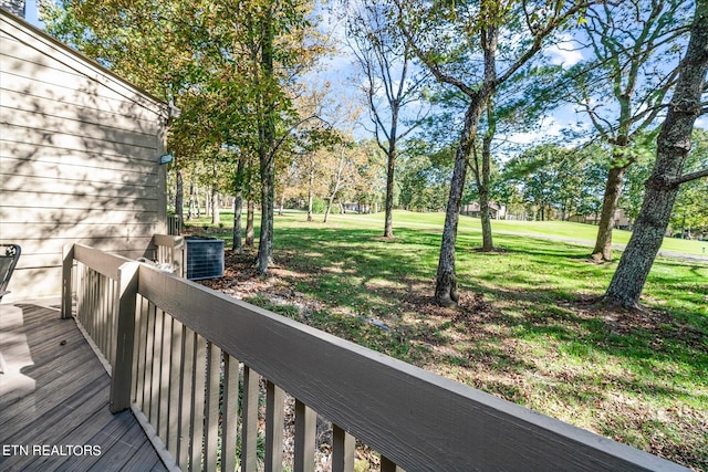 wooden deck featuring a yard and central AC