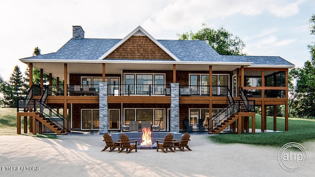 rear view of property featuring an outdoor fire pit, a patio, and a yard