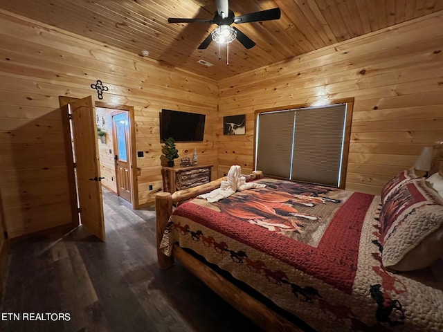 bedroom featuring ceiling fan, wooden walls, dark hardwood / wood-style floors, and wood ceiling