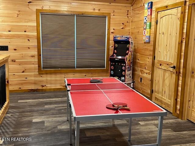 game room featuring wood walls and dark wood-type flooring