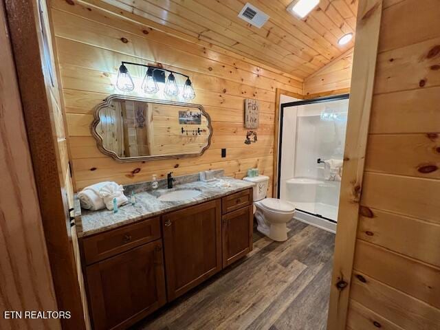 bathroom with lofted ceiling, vanity, walk in shower, and toilet