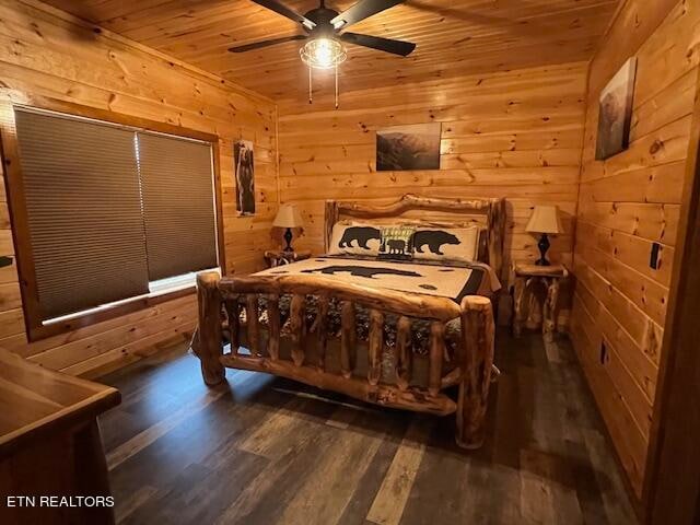 bedroom with wood walls, dark hardwood / wood-style floors, wood ceiling, and ceiling fan