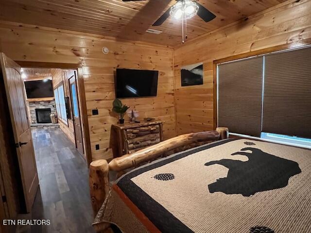 bedroom featuring wood walls, wood ceiling, and hardwood / wood-style flooring