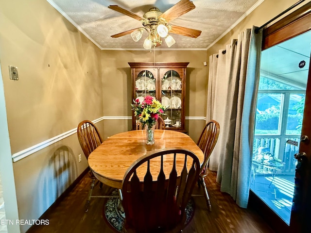 dining room featuring ceiling fan, a textured ceiling, crown molding, and dark hardwood / wood-style flooring