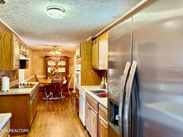 kitchen featuring ceiling fan, hardwood / wood-style flooring, a textured ceiling, and white appliances