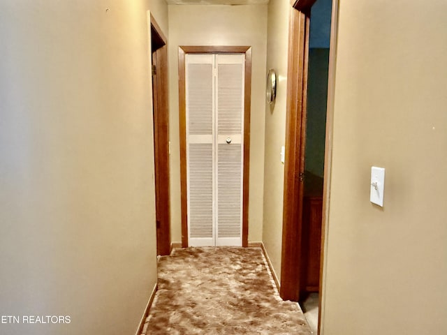 hall featuring carpet floors and baseboards