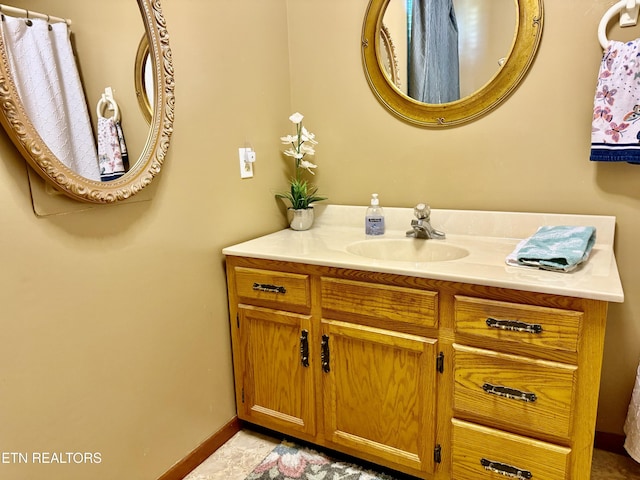 bathroom with baseboards and vanity