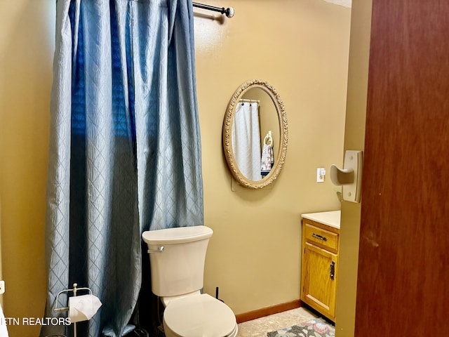 full bathroom featuring vanity, baseboards, and toilet