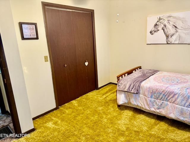 bedroom with light carpet and a closet