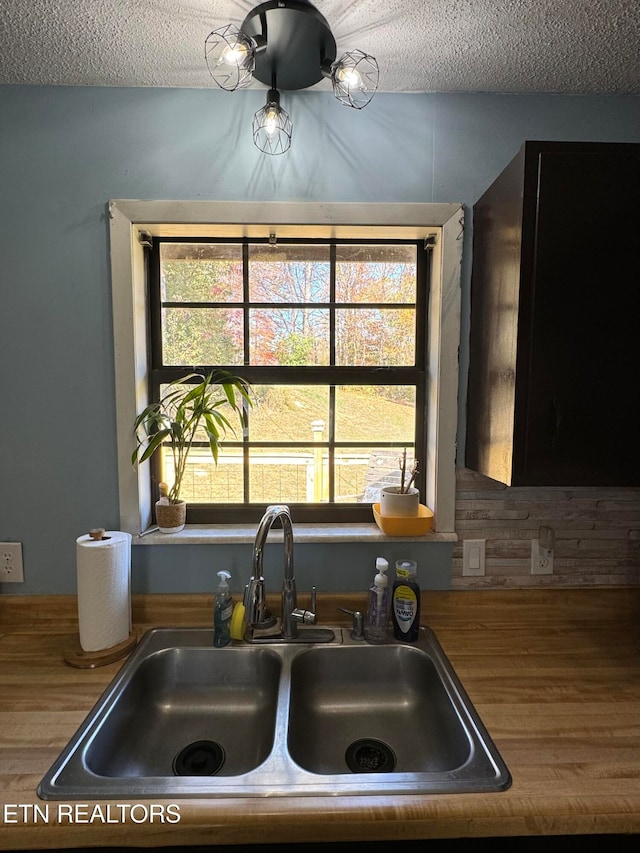 kitchen with a sink and a textured ceiling