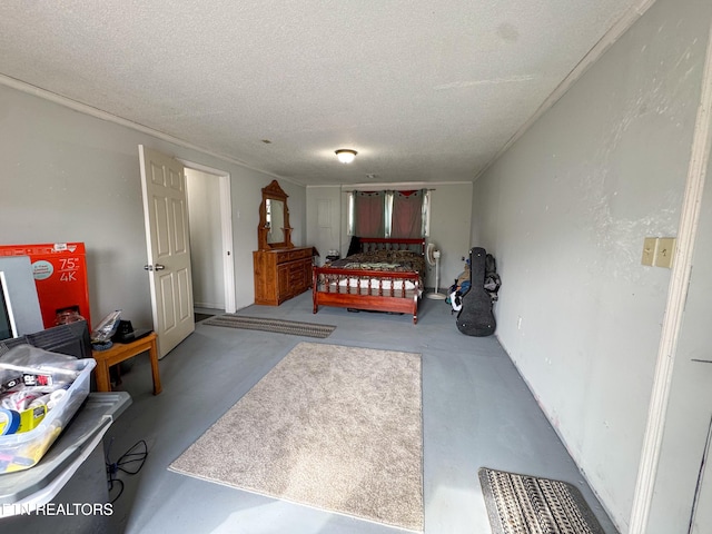 bedroom with concrete floors and a textured ceiling