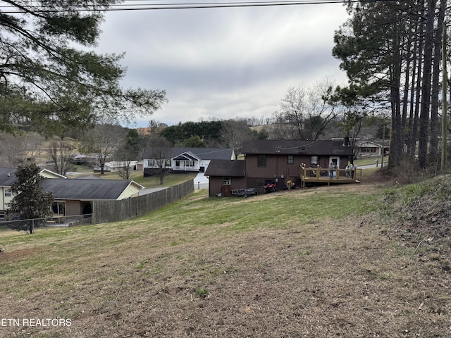 view of yard featuring fence and a wooden deck