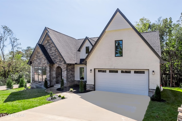 english style home featuring a front yard and a garage