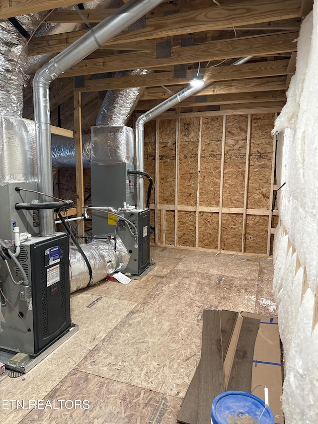 unfinished attic featuring heating unit