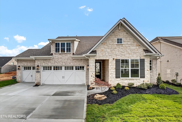 craftsman-style house featuring an attached garage, a shingled roof, stone siding, and concrete driveway