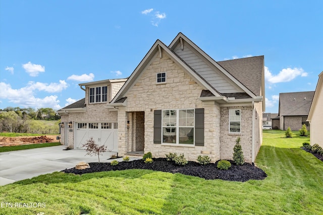 view of front of property with a front lawn, stone siding, driveway, and roof with shingles