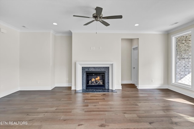 unfurnished living room featuring crown molding, recessed lighting, and wood finished floors