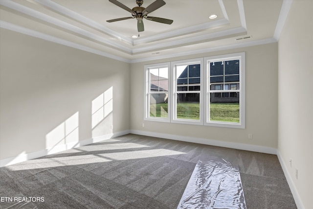 unfurnished room featuring crown molding, visible vents, carpet flooring, a raised ceiling, and baseboards