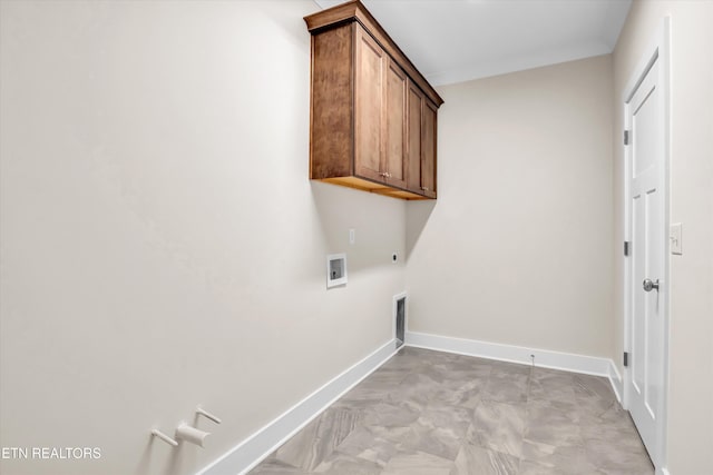 laundry room with baseboards, gas dryer hookup, hookup for an electric dryer, cabinet space, and hookup for a washing machine
