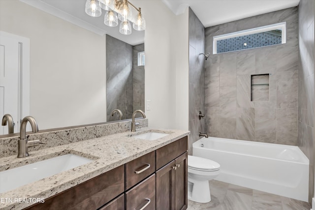 bathroom featuring toilet, double vanity, a sink, and shower / bathtub combination