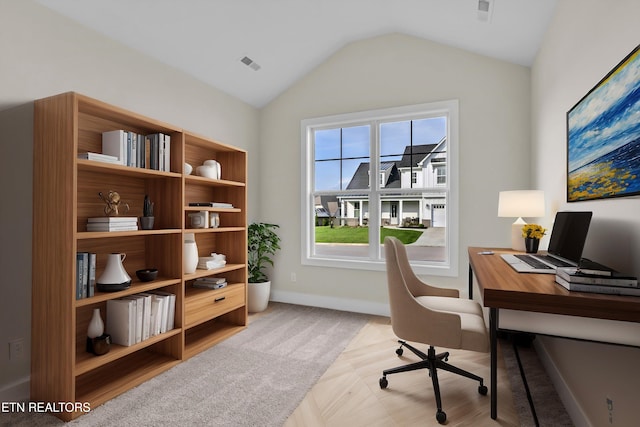 home office featuring visible vents, baseboards, and vaulted ceiling