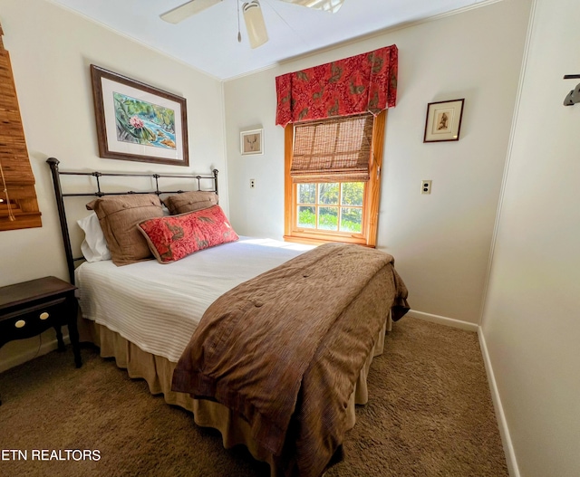 bedroom featuring ceiling fan, crown molding, and dark colored carpet