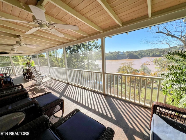 sunroom with beamed ceiling, wood ceiling, a water view, and a healthy amount of sunlight