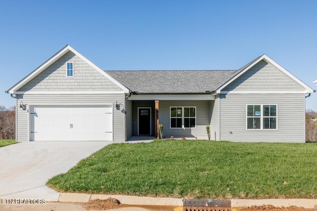 view of front of home featuring a garage and a front lawn