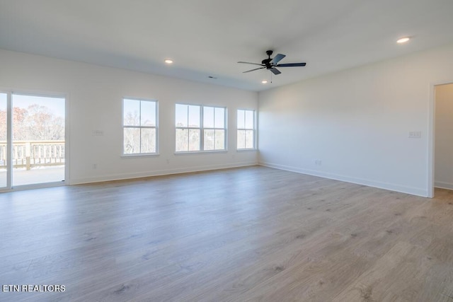 spare room with ceiling fan and light hardwood / wood-style flooring