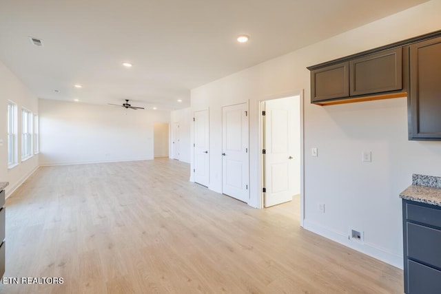 spare room with ceiling fan and light hardwood / wood-style floors