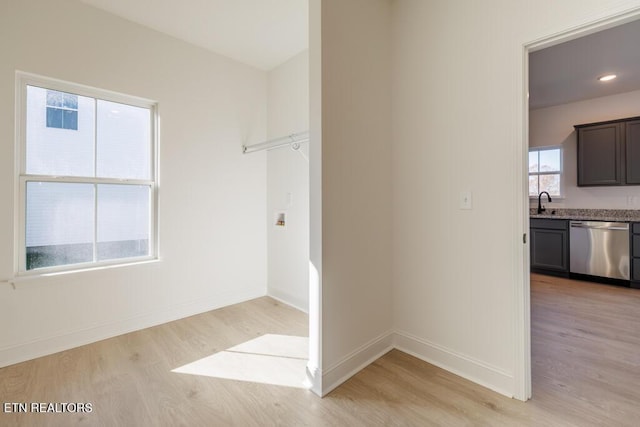 interior space with light hardwood / wood-style flooring and sink