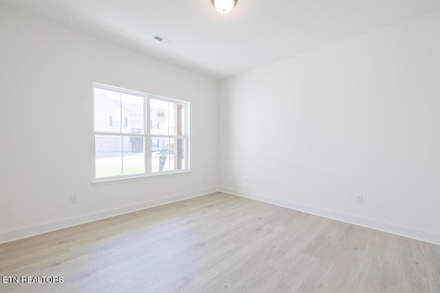 spare room featuring light wood-type flooring