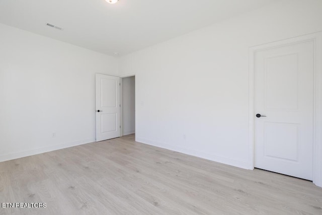 spare room featuring light wood-type flooring