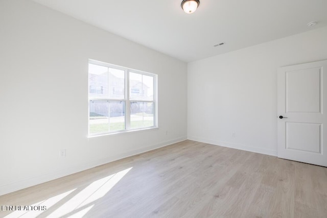 spare room featuring light hardwood / wood-style flooring