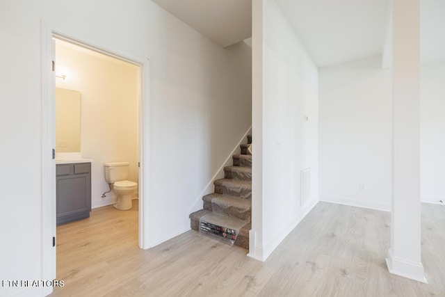 staircase featuring wood-type flooring