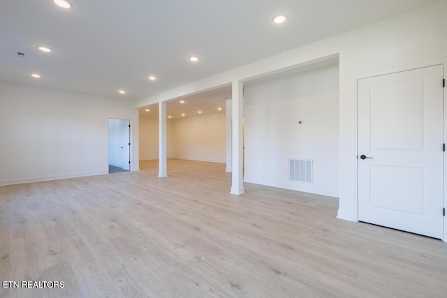 basement with light hardwood / wood-style floors