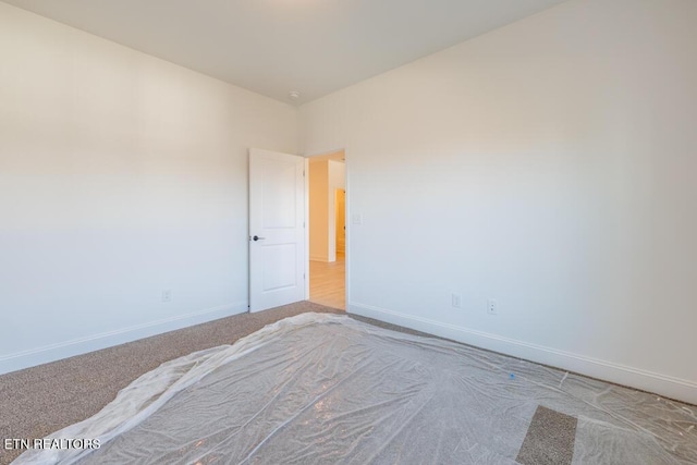 unfurnished bedroom featuring light colored carpet