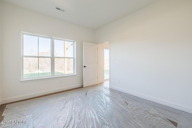 unfurnished room featuring a wealth of natural light