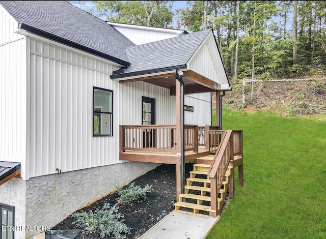 view of home's exterior featuring a wooden deck and a lawn