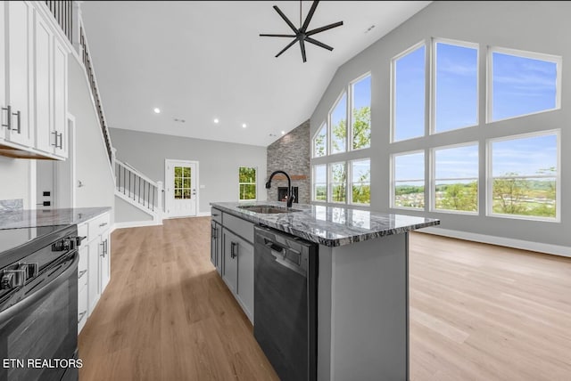 246 Clear Creek Rd, Kodak, TN 37764 - kitchen featuring dishwasher, high vaulted ceiling, a sink, electric range, and dark stone counters