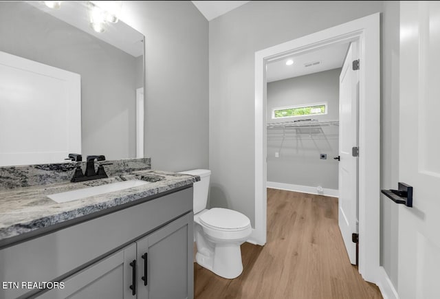 246 Clear Creek Rd, Kodak, TN 37764 - bathroom with wood finished floors, vanity, toilet, and a walk in closet