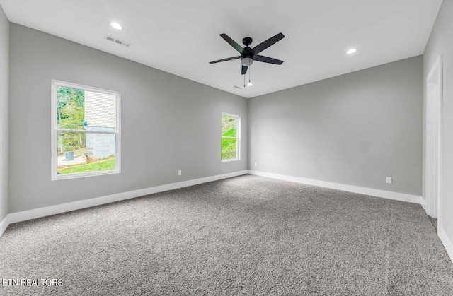 unfurnished room featuring ceiling fan, plenty of natural light, and carpet flooring