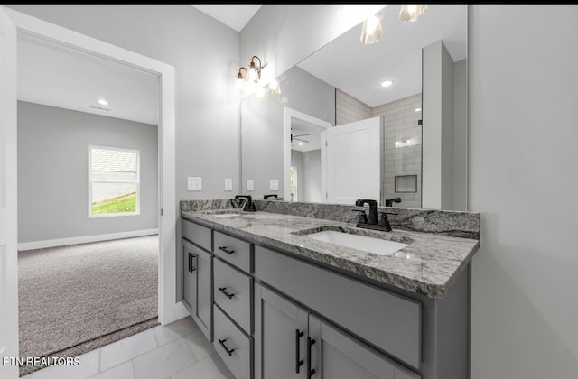246 Clear Creek Rd, Kodak, TN 37764 - bathroom with double vanity, a tile shower, baseboards, tile patterned floors, and recessed lighting