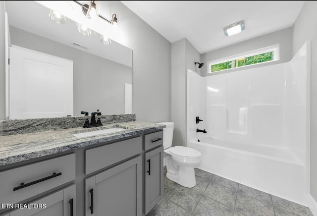 full bathroom featuring shower / bathing tub combination, vanity, toilet, and tile patterned floors