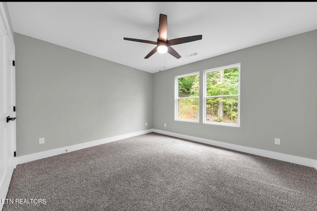 empty room with ceiling fan and carpet flooring